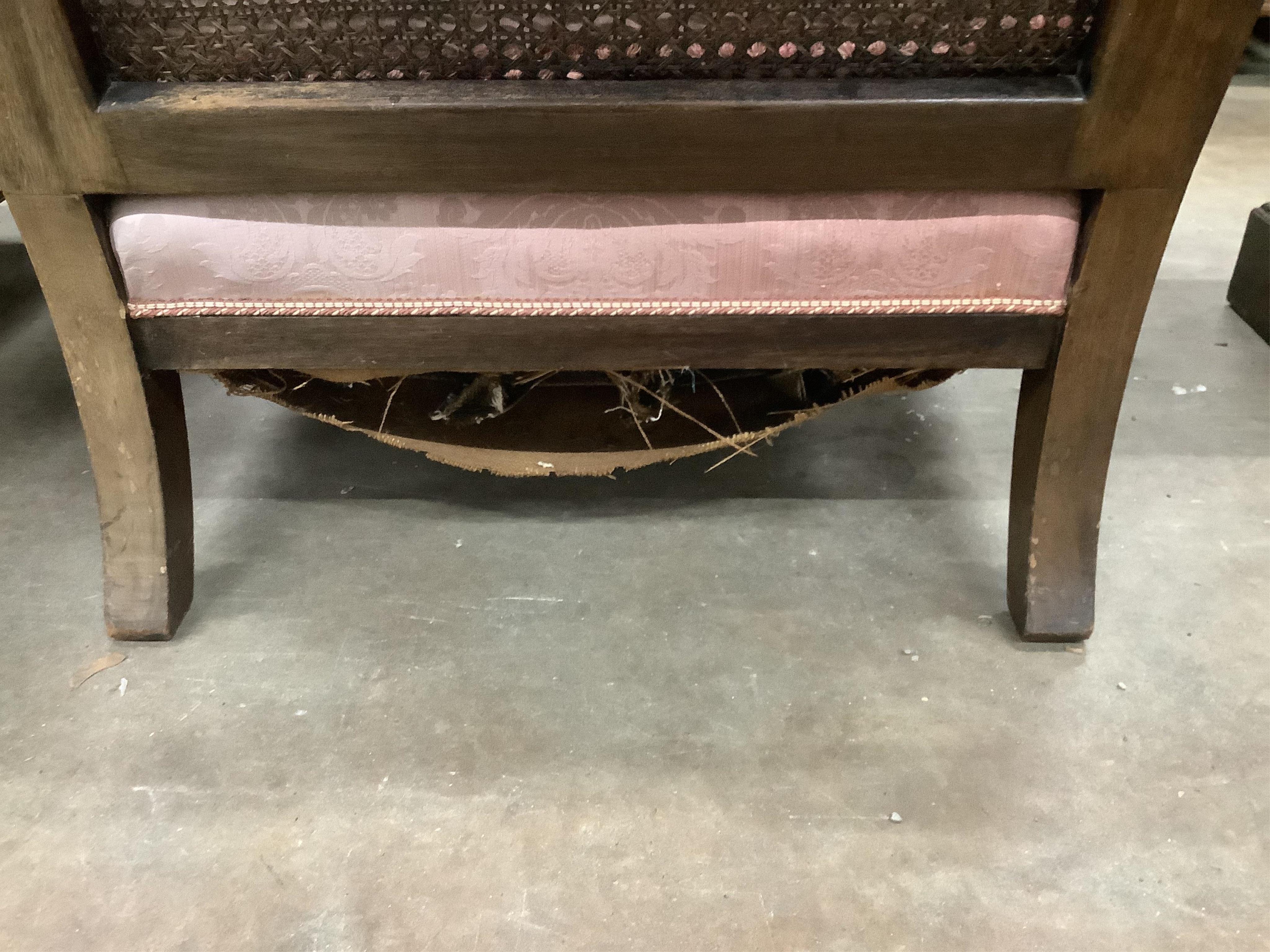 A 1930's mahogany three piece Bergere suite, with double caned arms and single caned backs. Condition - some fading with small damages to the caning